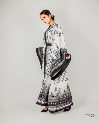 Elegant black and white gown with intricate Palestinian shawl-inspired patterns, featuring mosque motifs and geometric designs. Visit www.mnourdesign.com for more.
