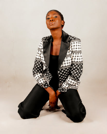 Statement black and white blazer from the HORRA collection by MNour Design, inspired by the keffiyeh pattern and tailored with a sleek satin lapel. A bold fusion of tradition and modernity for the empowered woman. Discover more at www.mnourdesign.com.
