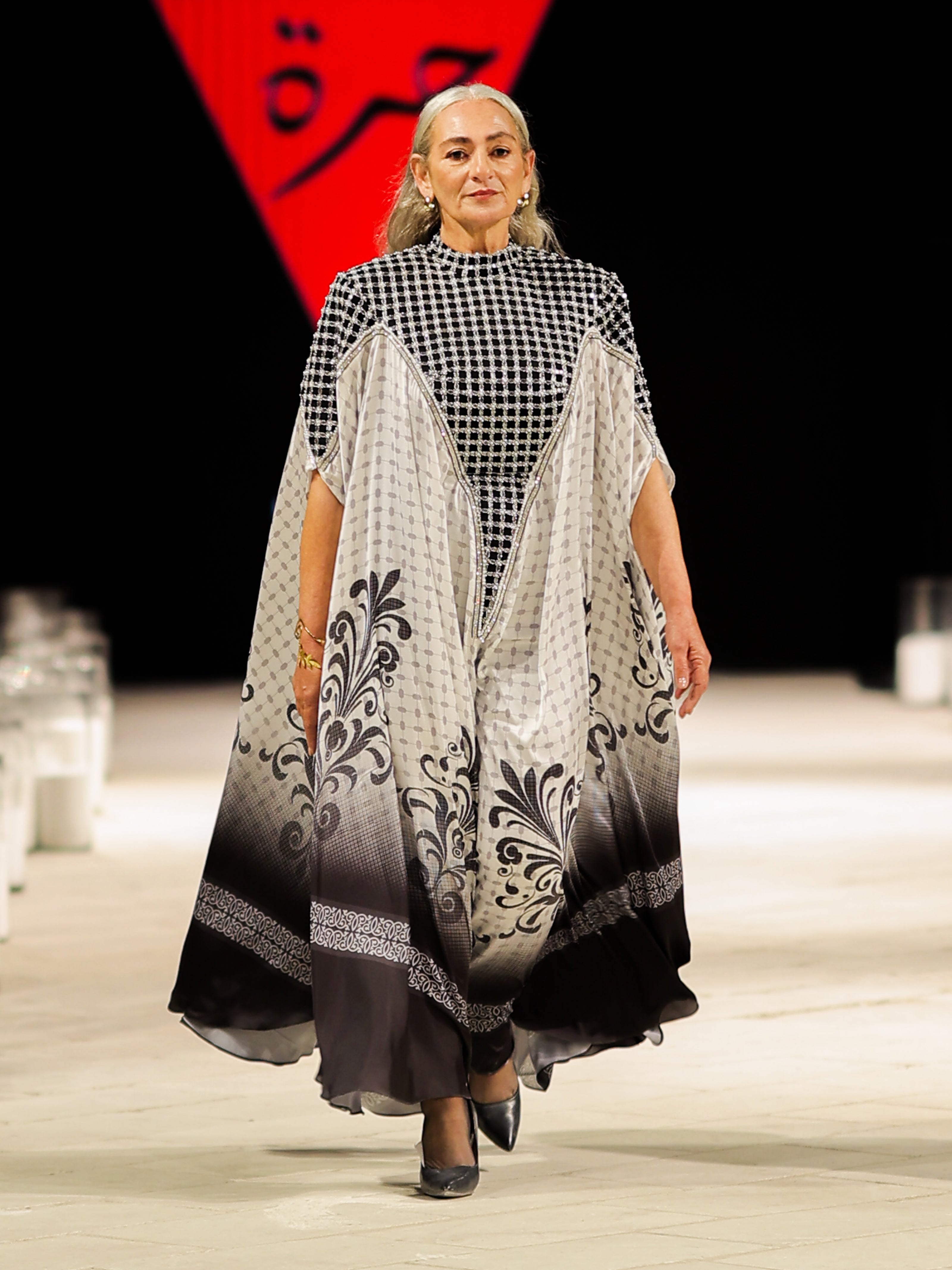 A stunning model gracefully poses in an elegant haute couture dress from the Horra Collection by designer Mohamed Nour, showcasing intricate details and luxurious craftsmanship