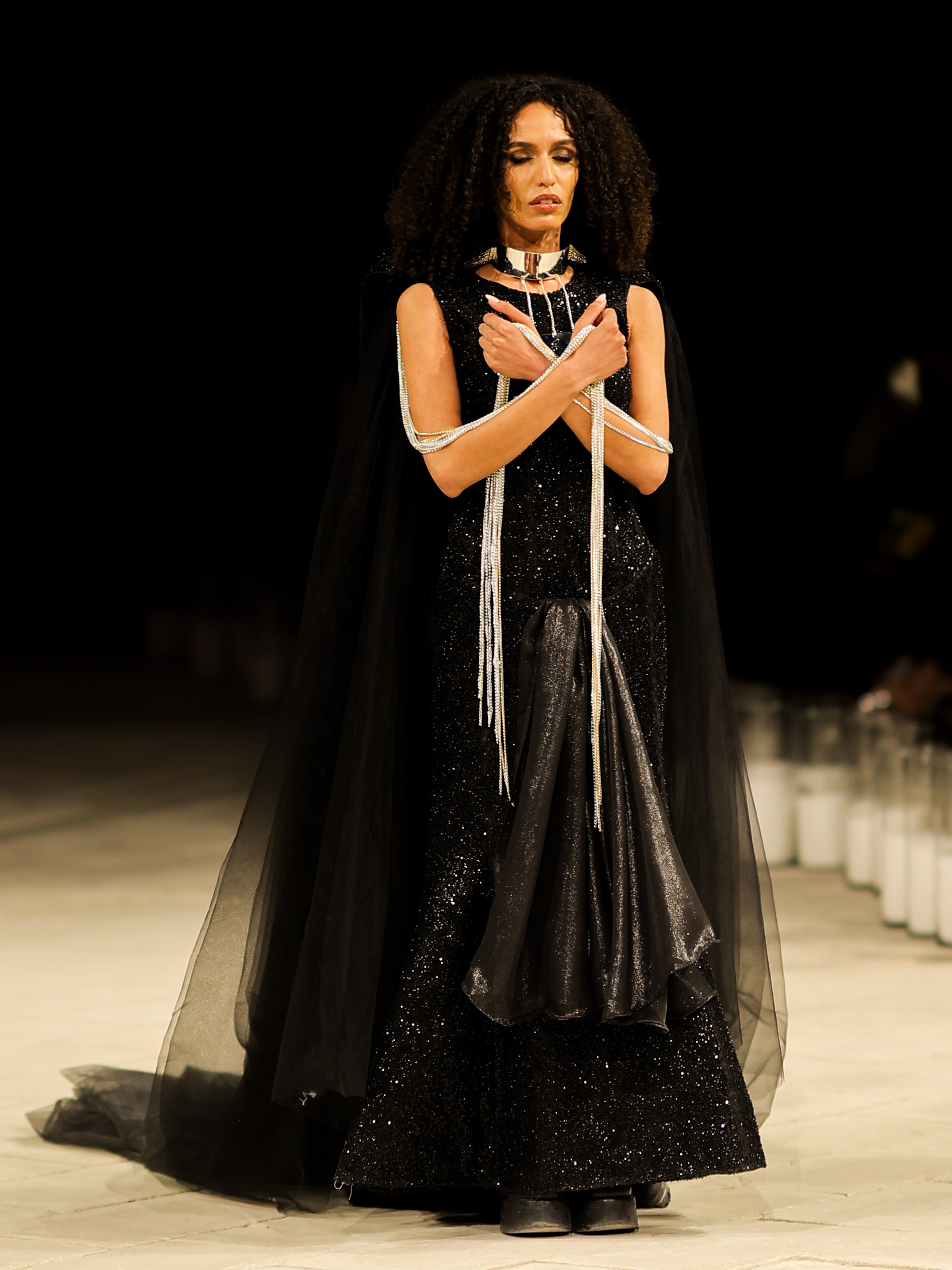 A stunning model gracefully poses in an elegant haute couture dress from the Horra Collection by designer Mohamed Nour, showcasing intricate details and luxurious craftsmanship
