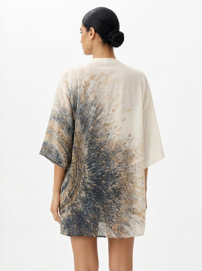 Woman wearing a tie-dye shirt with a white background