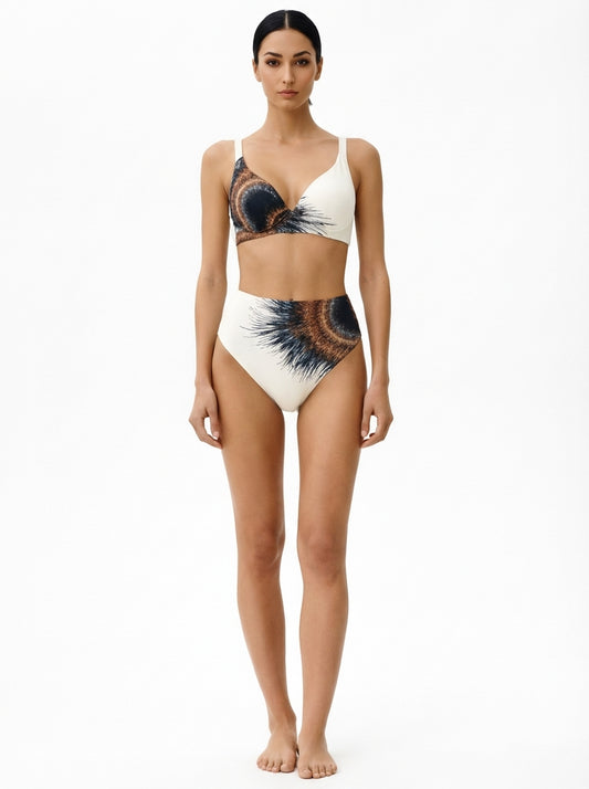 Woman wearing a white bikini with black and blue abstract patterns on a white background