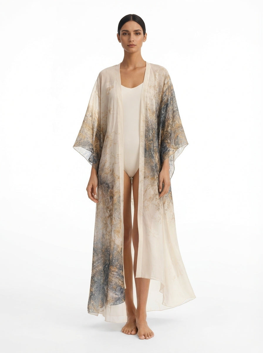 Woman wearing a long, sheer kimono-style garment over a white outfit on a white background