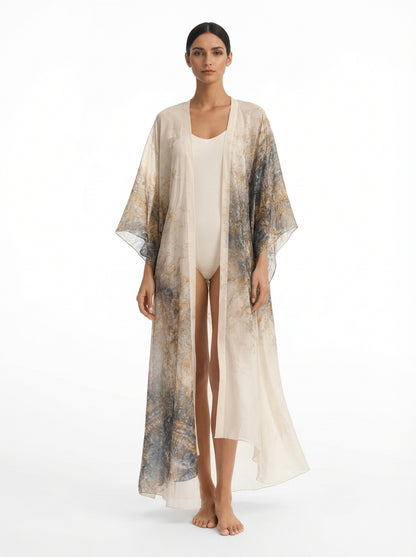 Woman wearing a long, sheer kimono-style garment over a white outfit on a white background