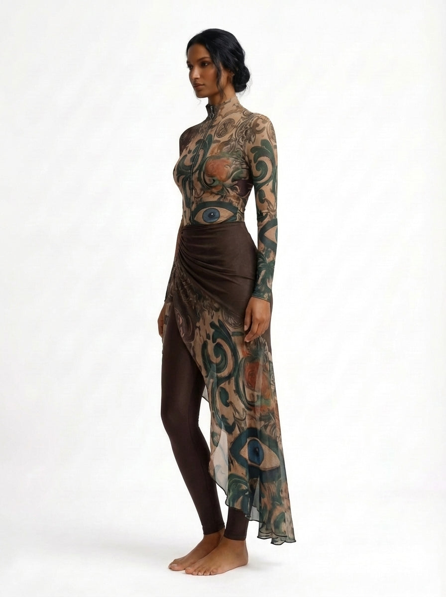 Woman wearing a long, patterned dress with a white background