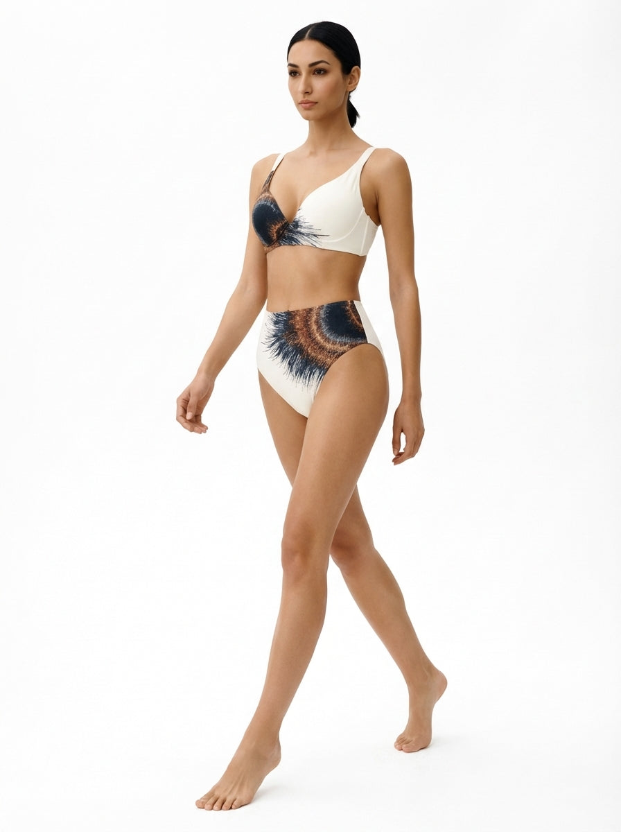 Woman wearing a white bikini with black and blue patterns on a white background