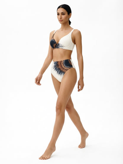 Woman wearing a white bikini with black and blue patterns on a white background
