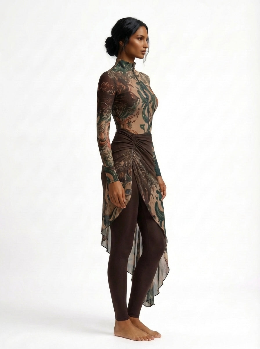 Woman wearing a long-sleeve, high-low dress with a camouflage pattern on a white background