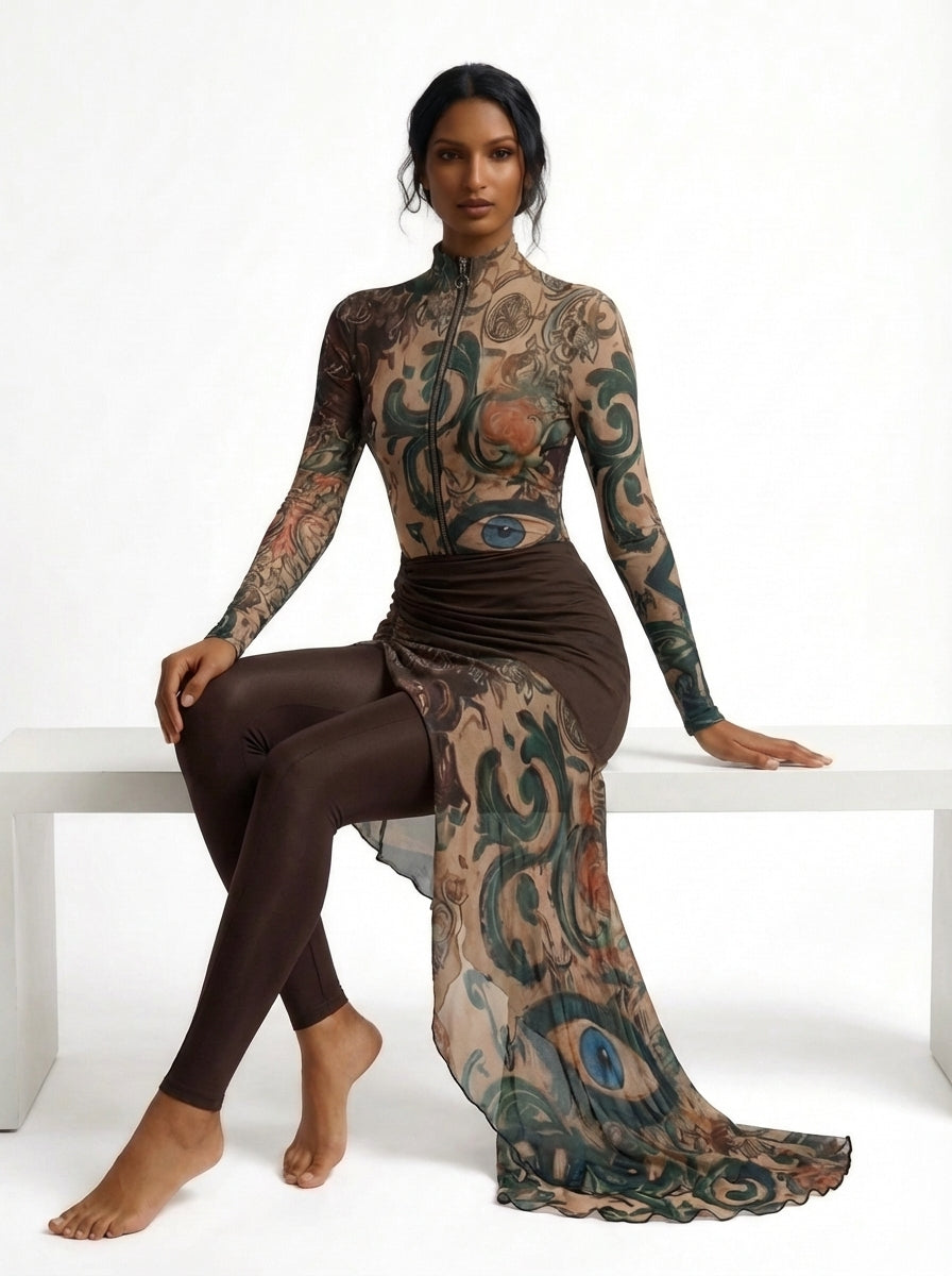 Woman with tattoos sitting on a white bench wearing a brown dress with a matching tattoo design.