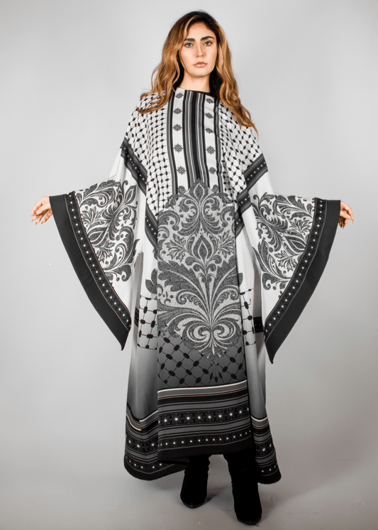 Elegant black and white abaya from the HORRA collection by MNour Design, featuring intricate architectural patterns and cultural motifs. A sophisticated blend of heritage and modern fashion. Discover more at www.mnourdesign.com