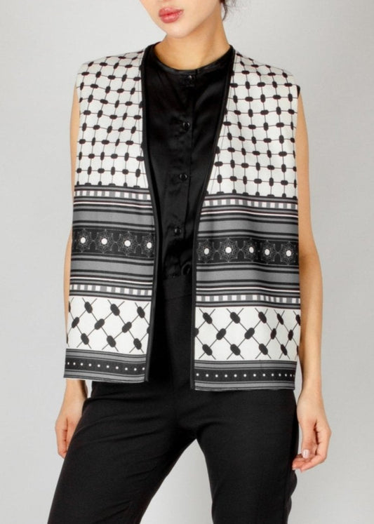 Modern sleeveless vest from the HORRA collection by MNour Design, featuring a striking black-and-white keffiyeh-inspired pattern. Styled with a sleek black satin blouse and tailored trousers for a bold and sophisticated look. Discover more at www.mnourdesign.com