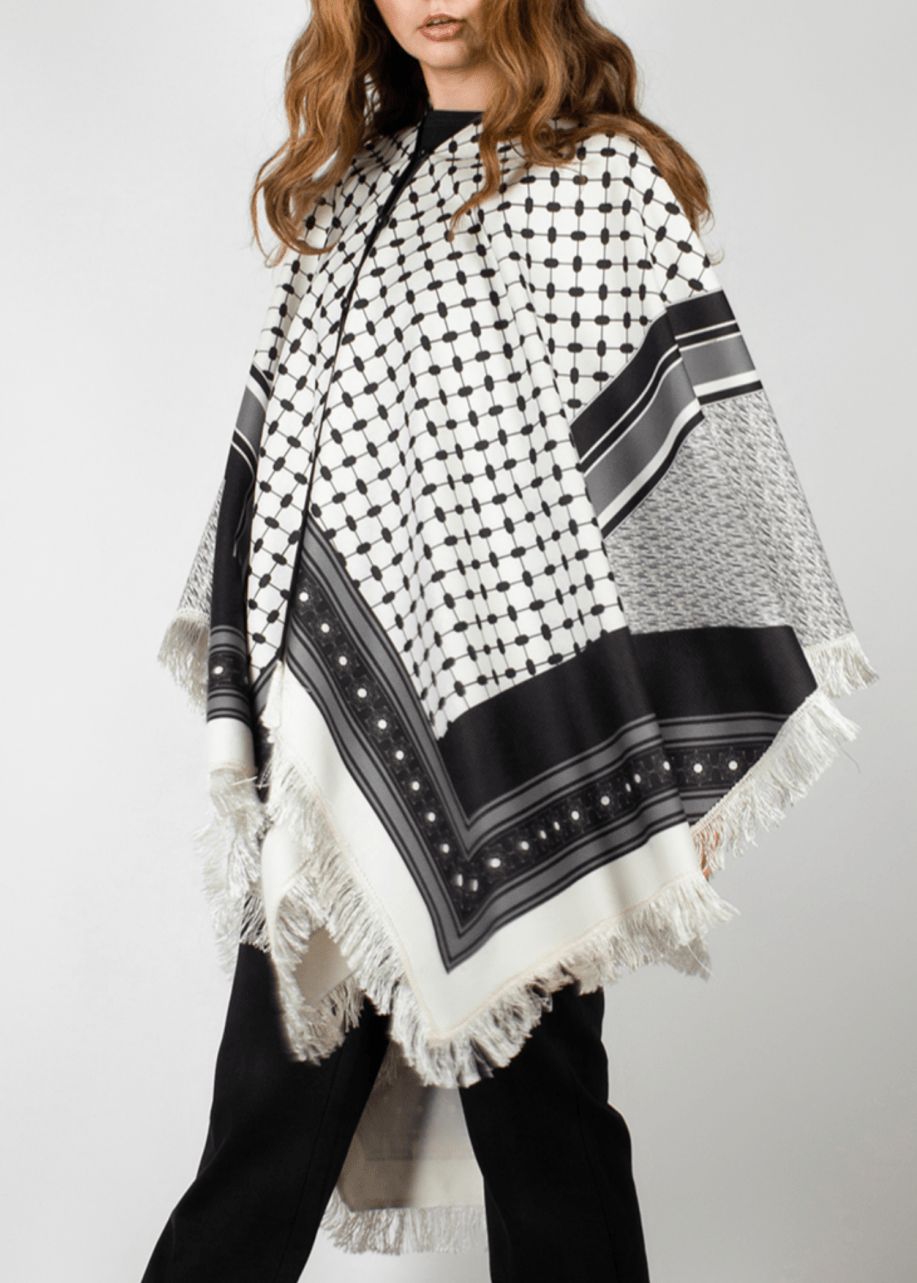 Elegant black and white poncho from the HORRA collection by MNour Design, inspired by traditional Palestinian keffiyeh patterns. Featuring intricate geometric details and delicate fringe edges, this timeless piece blends cultural heritage with modern sophistication. Discover more at www.mnourdesign.com