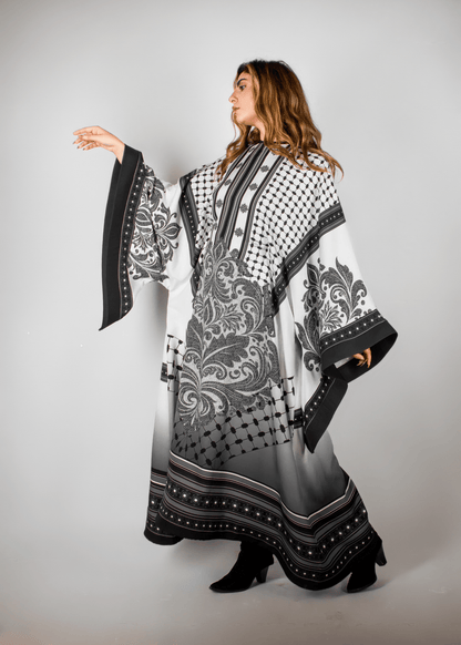 Stunning black and white abaya from the HORRA collection by MNour Design, featuring intricate architectural and cultural motifs. A graceful fusion of heritage and contemporary elegance. Explore more at www.mnourdesign.com