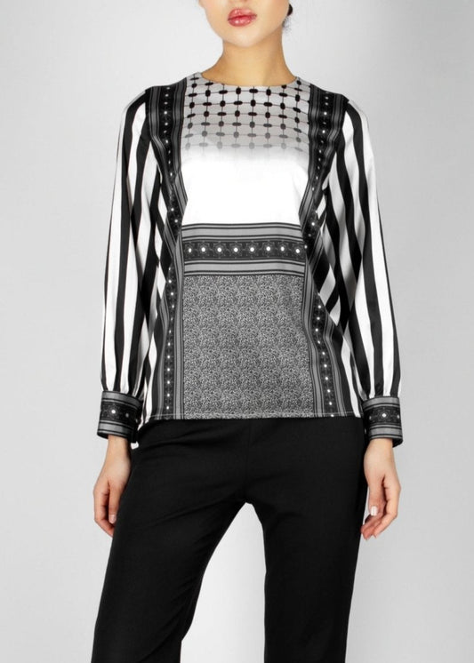 Modern black and white blouse from the HORRA collection by MNour Design, featuring keffiyeh-inspired patterns and bold stripes. A sophisticated fusion of heritage and contemporary fashion. Explore more at www.mnourdesign.com