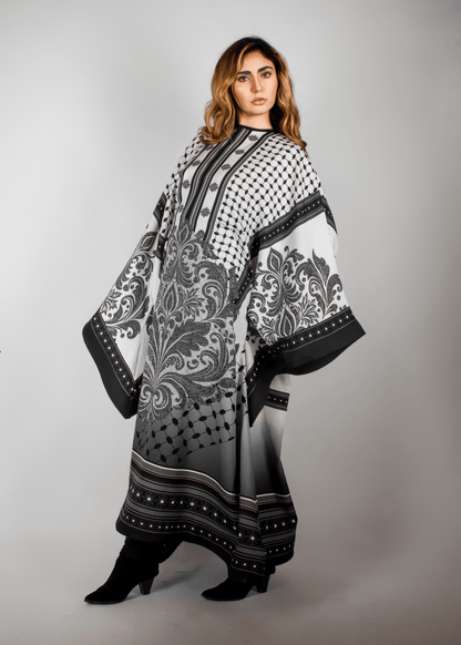 Elegant black and white abaya from the HORRA collection by MNour Design, featuring intricate architectural patterns and cultural motifs. A sophisticated blend of heritage and modern fashion. Discover more at www.mnourdesign.com