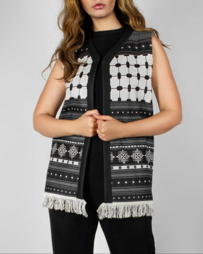 Modern black and white vest from the HORRA collection by MNour Design, featuring intricate geometric and traditional patterns with delicate fringe detailing. Styled over a sleek black ensemble for a contemporary yet culturally inspired look. Discover more at www.mnourdesign.com