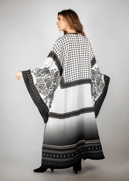 Elegant black and white abaya from the HORRA collection by MNour Design, featuring intricate architectural patterns and cultural motifs. A sophisticated blend of heritage and modern fashion. Discover more at www.mnourdesign.com